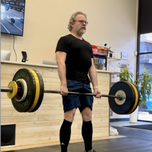 Man deadlifting 128kg